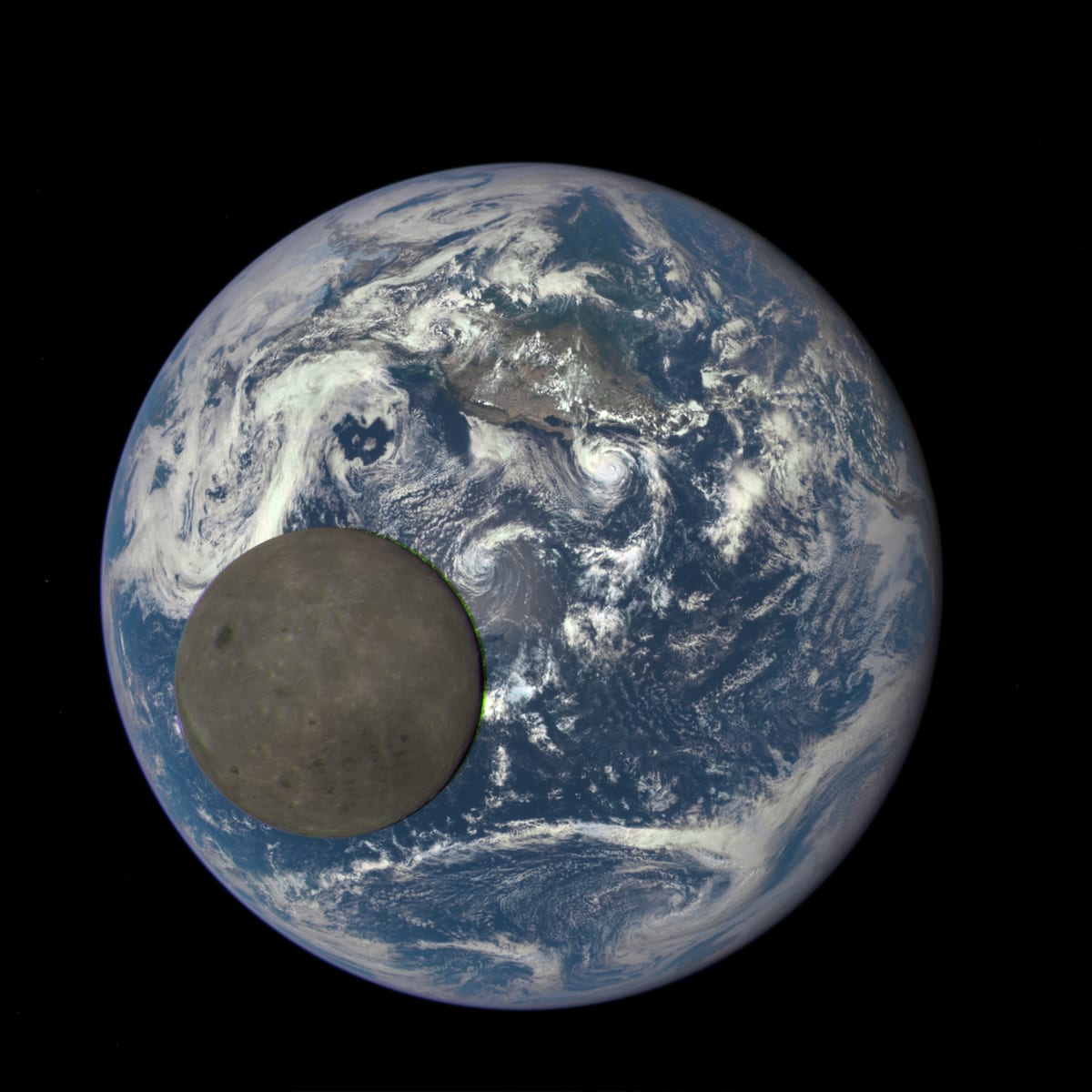 The grey far side of the Moon passing in front of a fully lit Earth, whose blue oceans and swirling white clouds fill the frame behind it